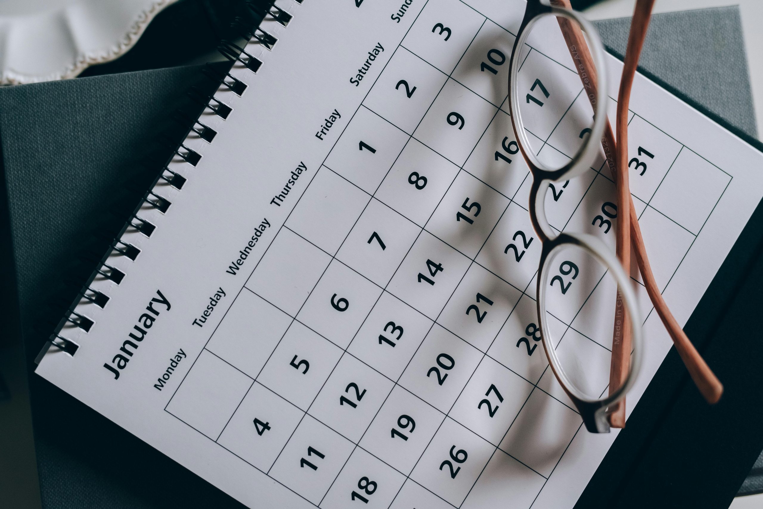 Brown framed eyeglasses on a calendar
